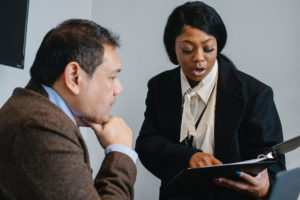 Two professionals talking over documents