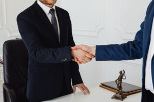 Client shaking hands with attorney